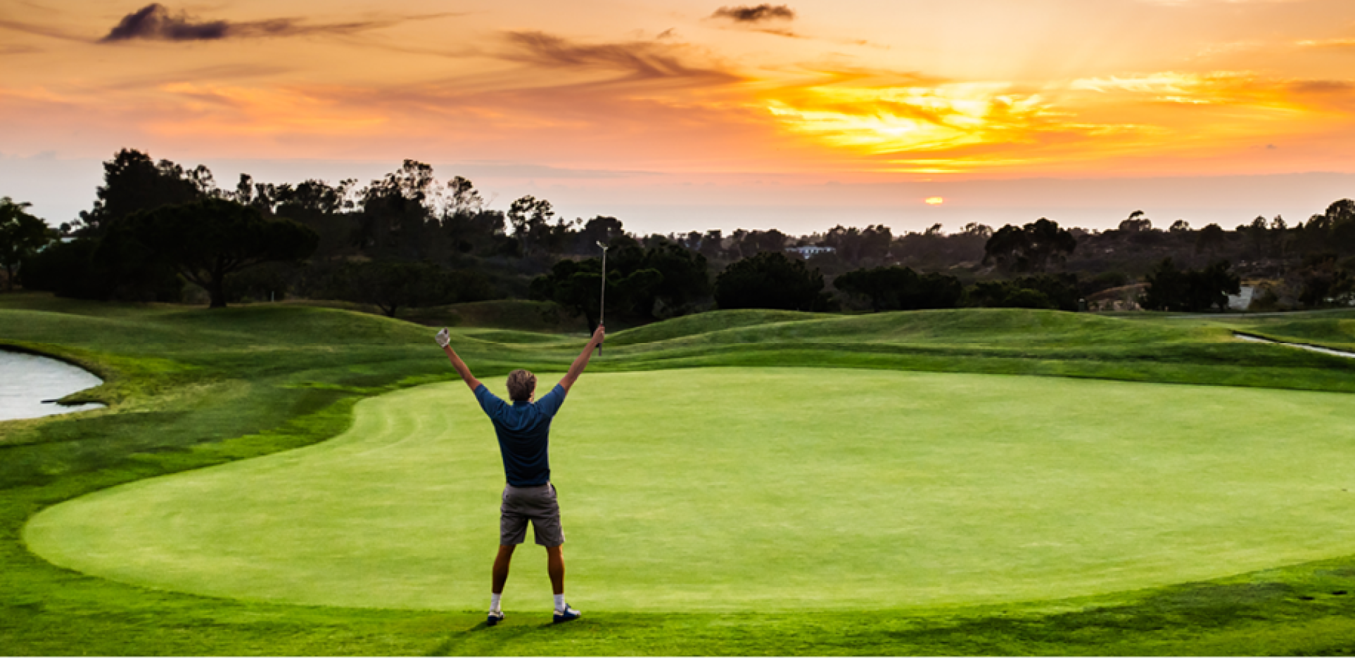 Golfer on golf course at sunrise